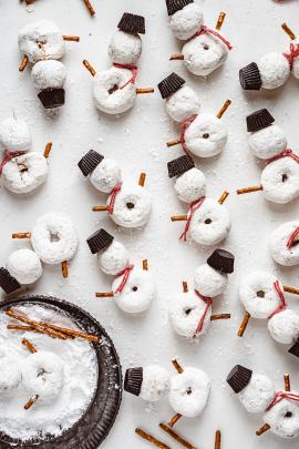 Snowman made with mini donuts and pretzels sticks 