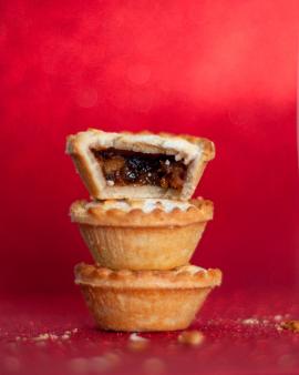 Christmas mince pies on red table