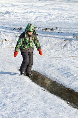 Boy Are Sliding on Ice Rink Trying Not To Fall Down