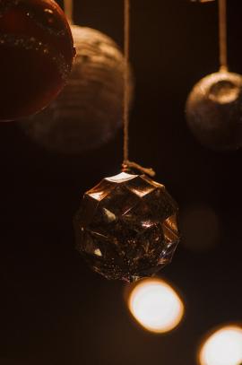 Gold themed christmas ornaments on dark background