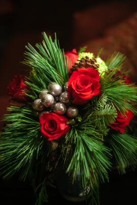 Christmas Florals with pine branches, frasier fir branches, pinecones, red roses and silver balls