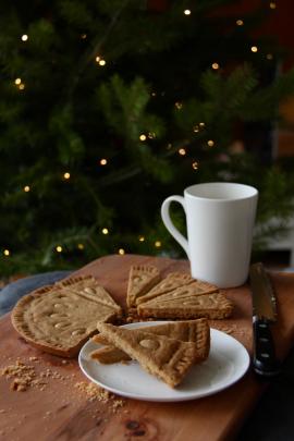 Christmas baking with a mug in front of Christmas tree - holiday cozy moment