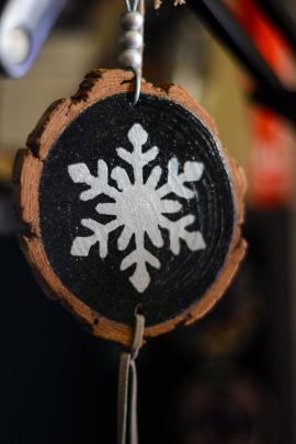 A beautiful handmade wooden Christmas gift with a snow in the center.