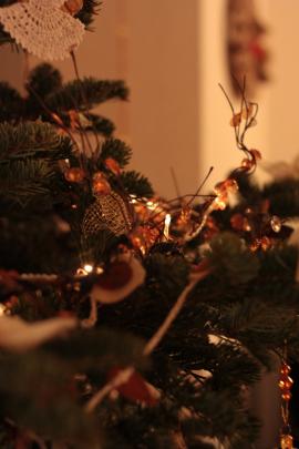 Christmas tree decoration and lights in gold and amber tones