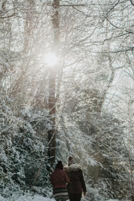 Two women taking a stroll through a snowy forest