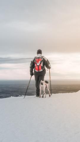 A hiker with his dog. On top of Untersberg in Salzburg, Austria.