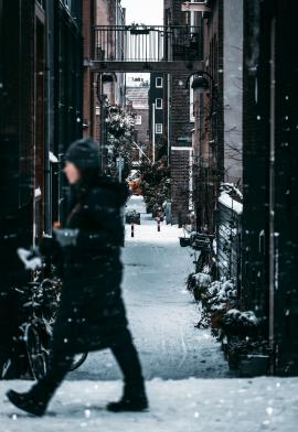 Woman on snowy street in Amsterdam