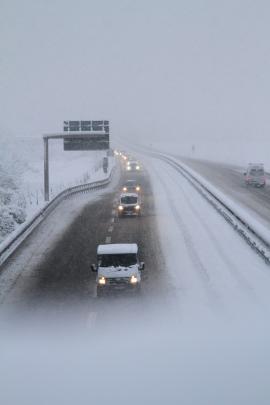 Cars drive through blizzard