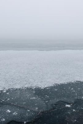 Snow on the ice, looking at the fog at Frölunda Nature Reserve, Stockholm