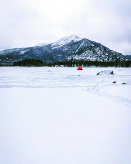 We went out to shoot in this frozen lake and got a cool surprise with the lone red fisher tent on the white backdrop!