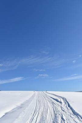 A snowmobile track under a blue sky, Saint-Paul, Québec, Canada