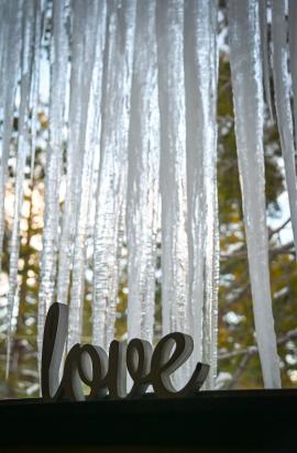 Love sign with icicles hanging in the background 