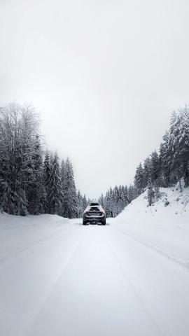 Car on a cold winter road in the Swedish forest.