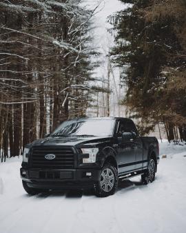 Ford F150 truck on a snow covered road in the mountains of Western, PA.