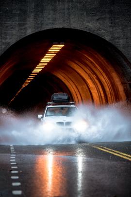 BMW X3 powers through a flooded Tunnel in Yosemite National park.